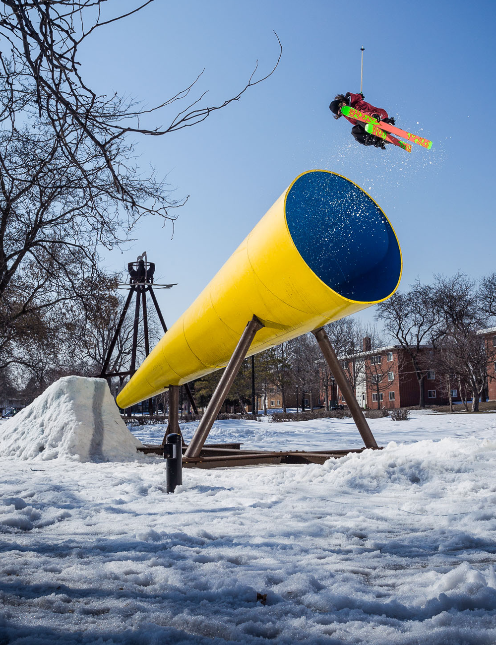 Skier Sean Jordan jumps off a massive tube into the air and grabs skis